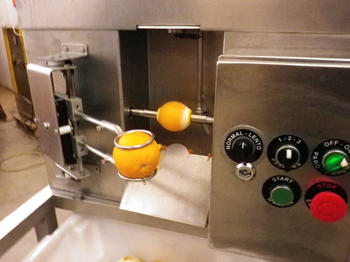 Pelamatic industrial orange peeler processing an orange